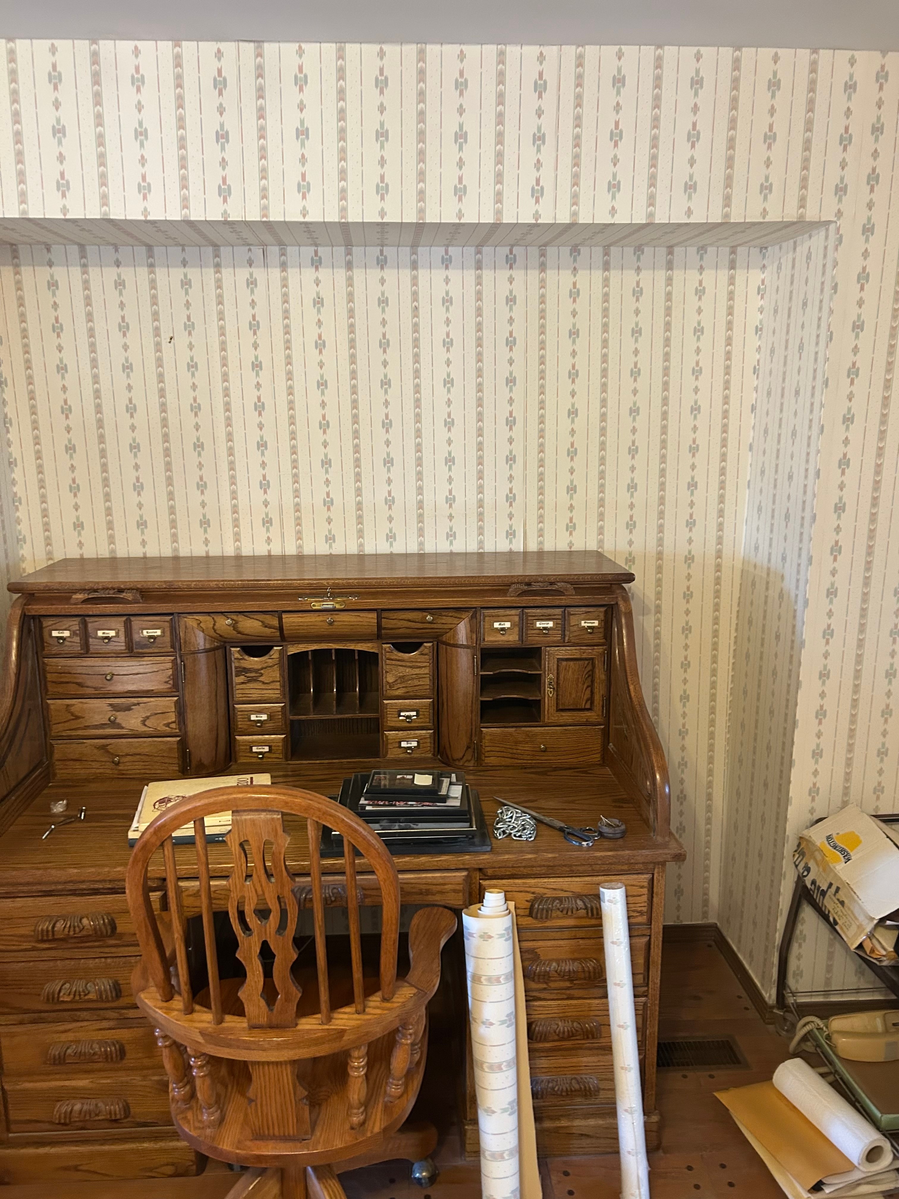 Interior wall with patterned wallpaper before refinishing